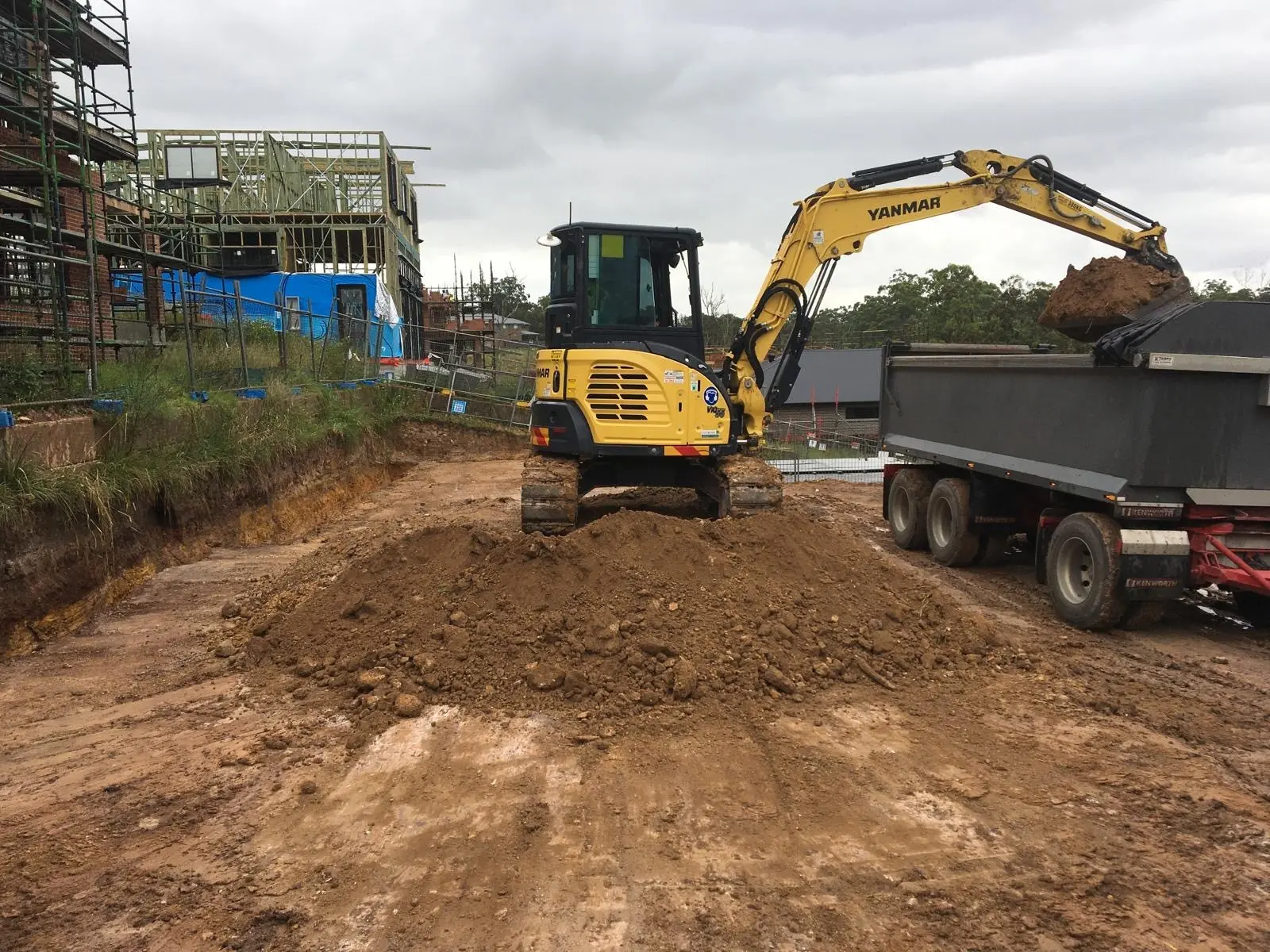 Compact excavator working in a narrow side access on a Sydney site